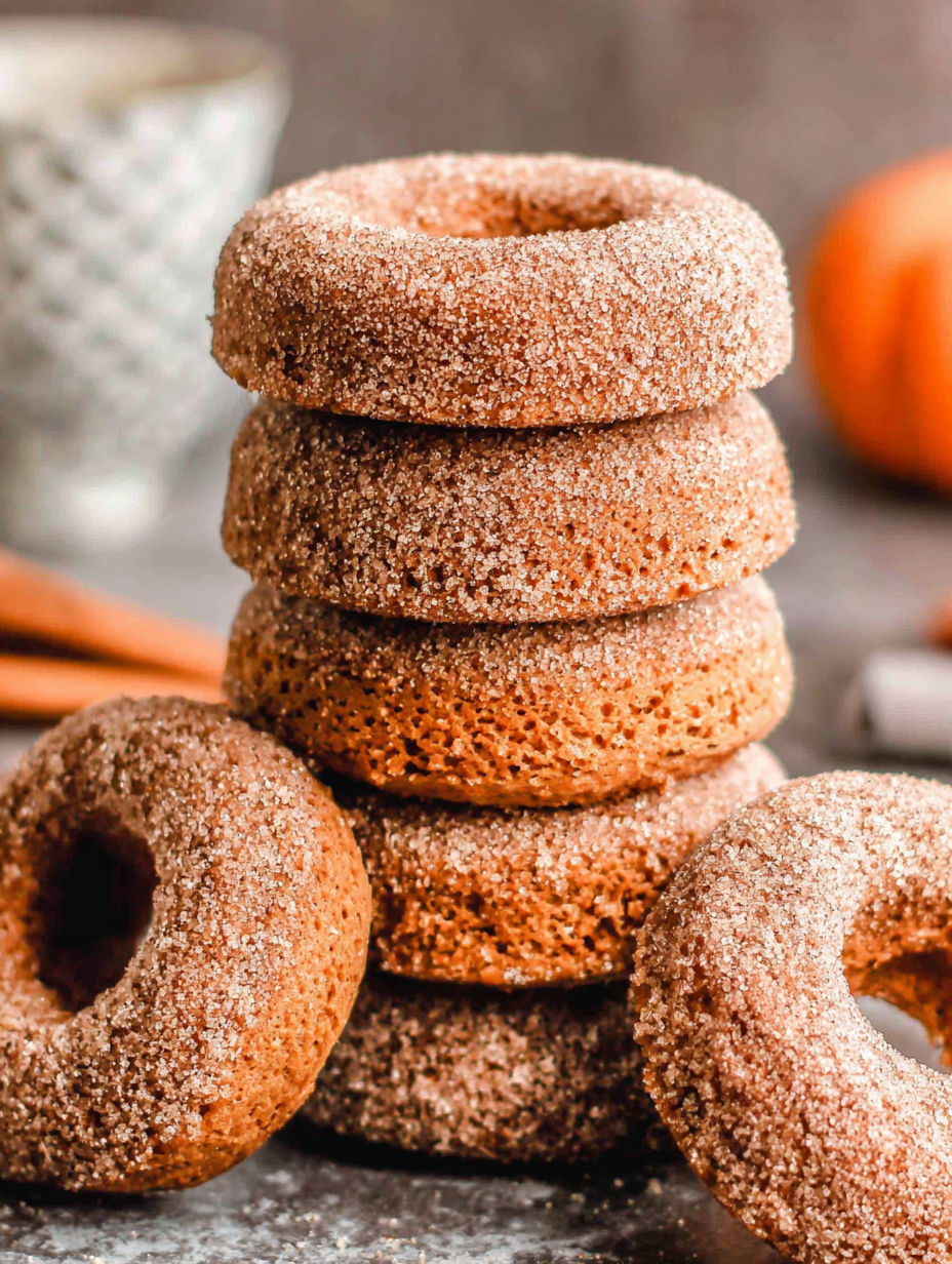 Pumpkin spice baked donuts stacked on top of each other.