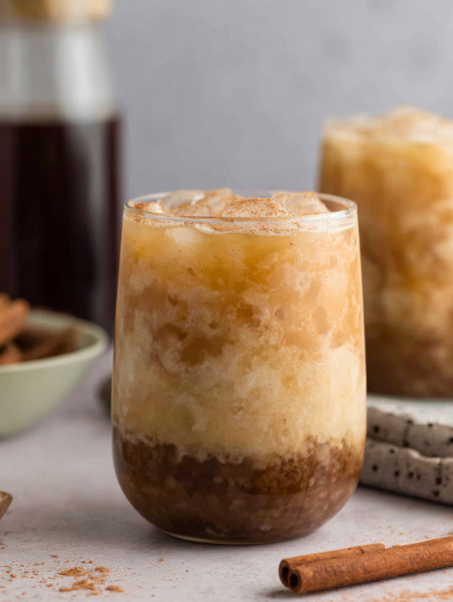 A glass of cinnamon flavored drink.