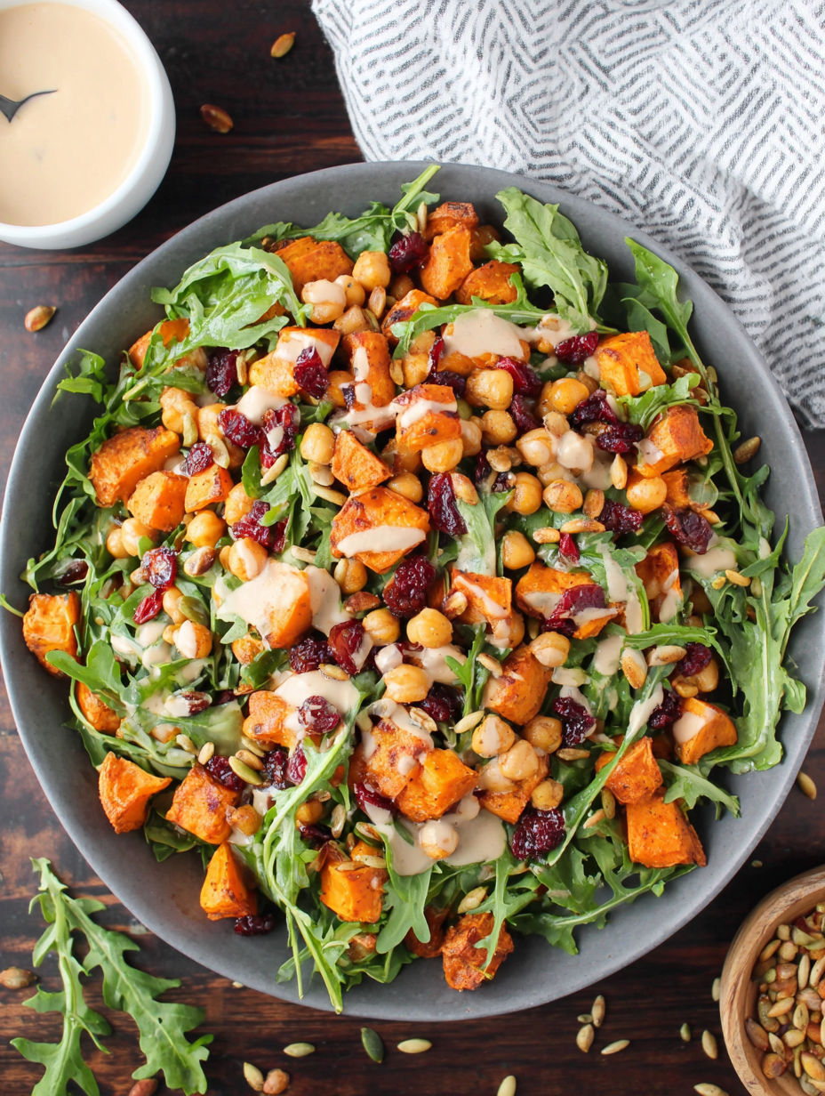 A bowl of roasted chickpea and sweet potato salad with a sweet tahini dressing.