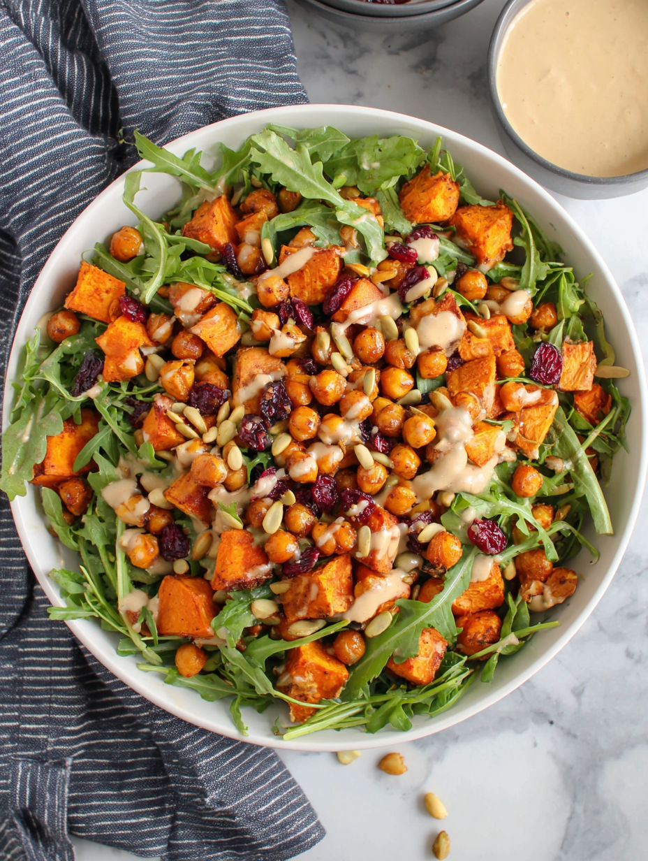 A bowl of roasted chickpea and sweet potato salad with sweet tahini dressing.