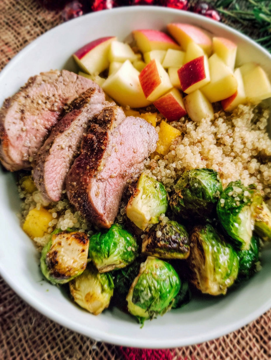 A bowl of food with meat, apples, and vegetables.