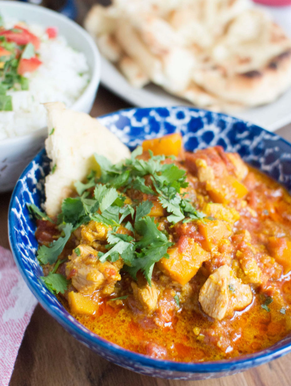 A bowl of chicken and butternut squash curry.