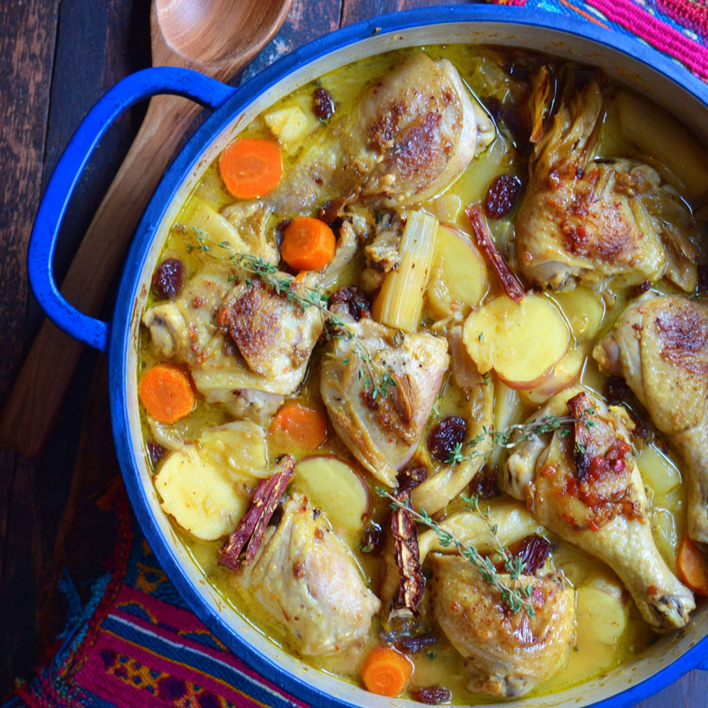A bowl of chicken stew with parsnips and carrots.