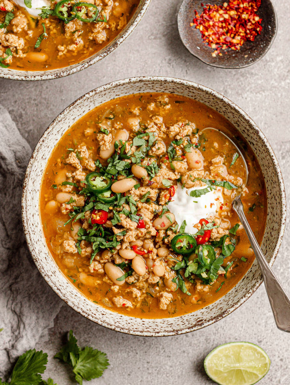 A bowl of chili with white beans and turkey.