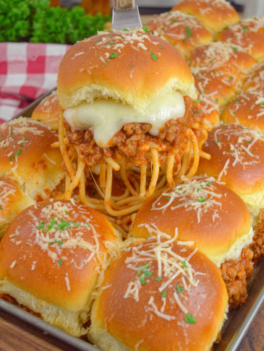 A tray of spaghetti sliders with cheese.