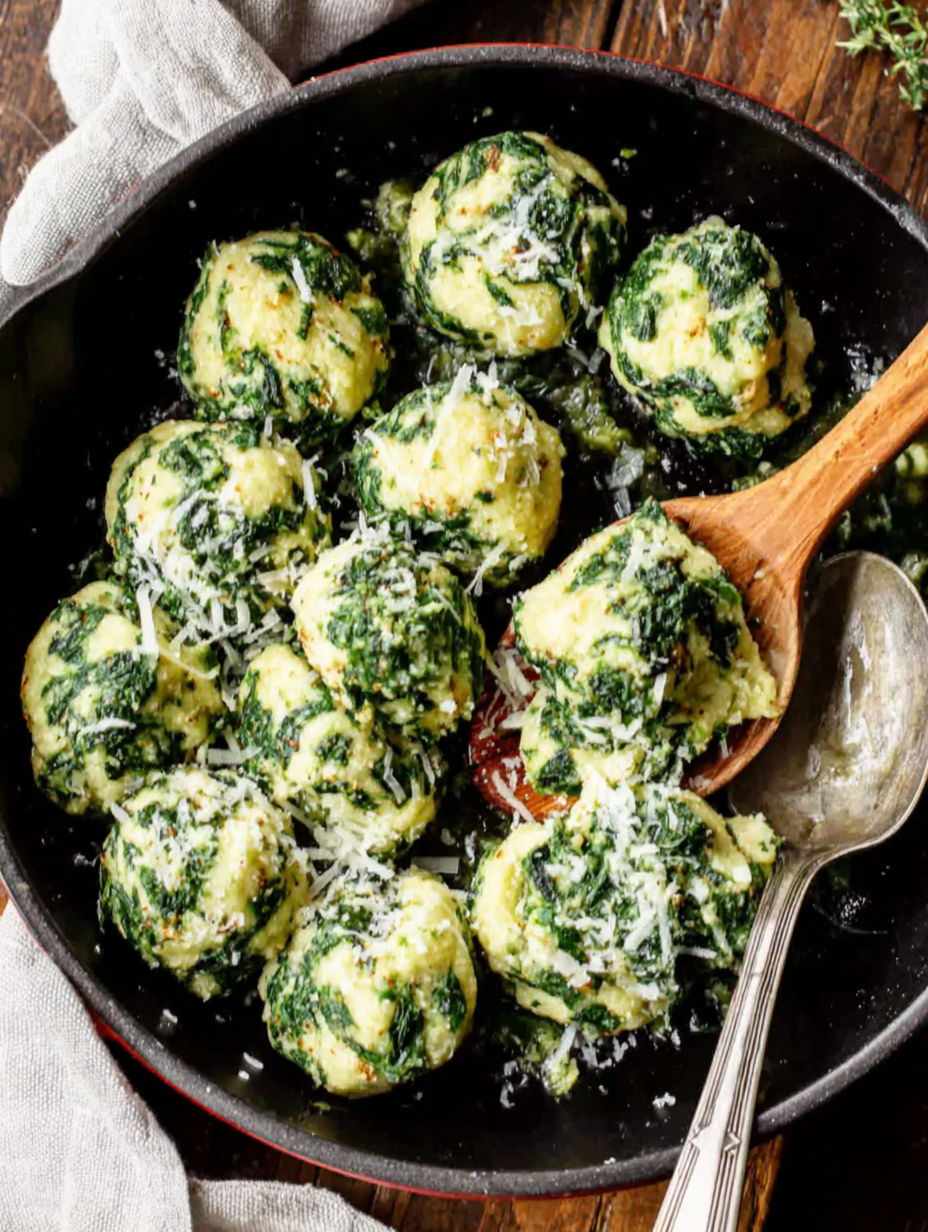 A pan of food with a wooden spoon in it.