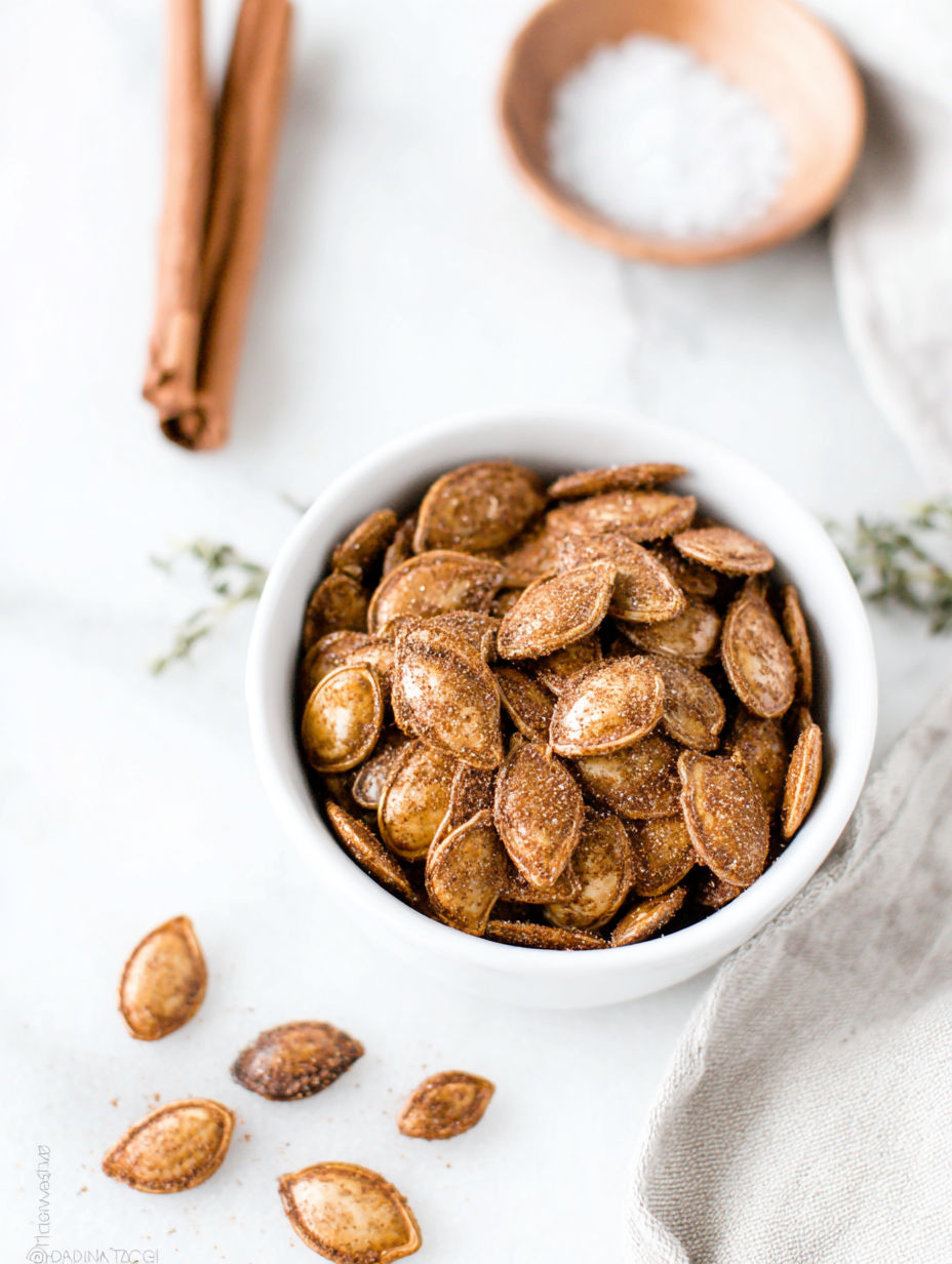 A bowl of pumpkin seeds on a table.