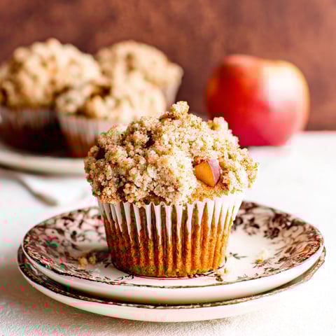 Two muffins with pumpkin streusel topping.