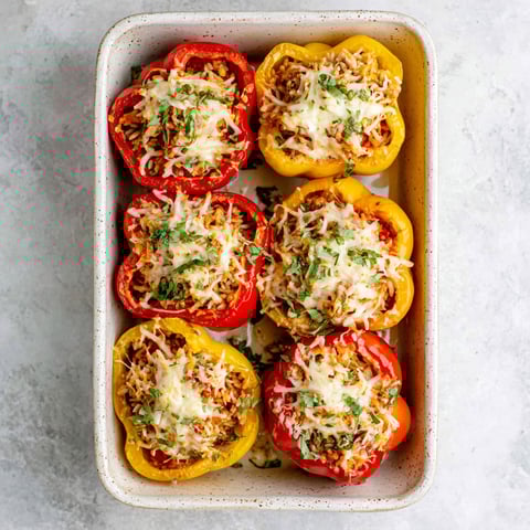 A dish of stuffed peppers with cheese and ground chicken.