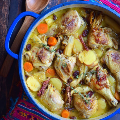 A bowl of chicken stew with parsnips and carrots.