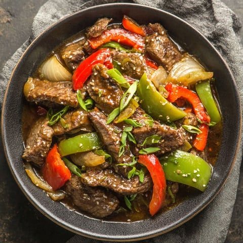 A bowl of beef and peppers.