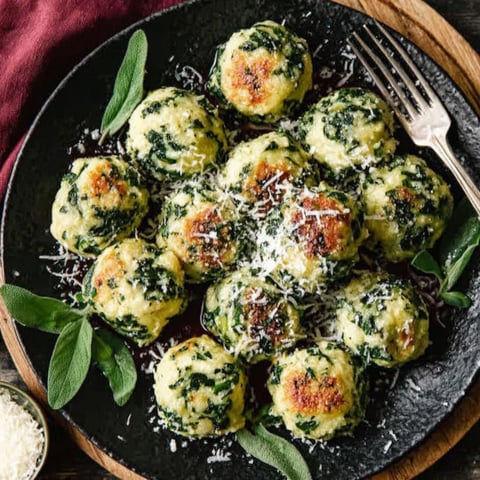 A plate of spinach ricotta dumplings.