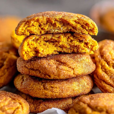 Pumpkin Snickerdoodle Cookies stacked on a plate.