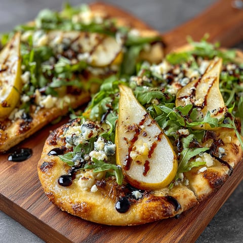 A gorgonzola pear flatbread on a wooden cutting board.