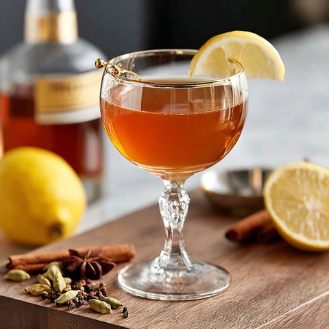 A glass of a spiced sidecar drink.
